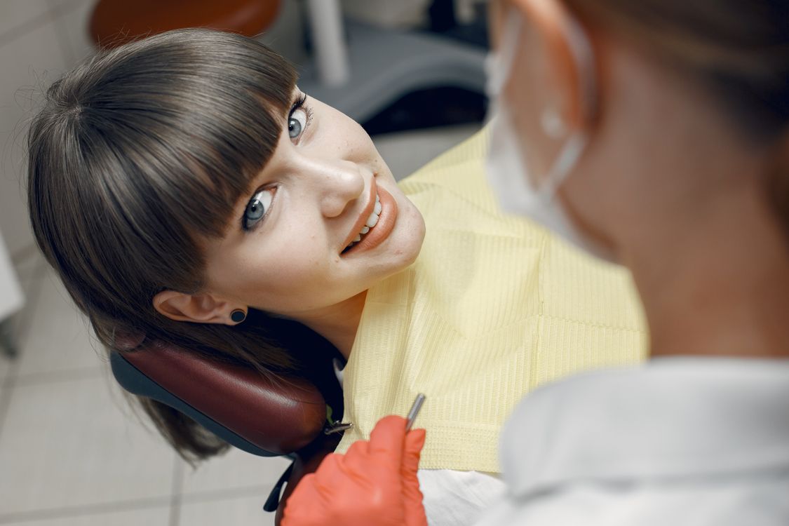 Smiling patient with her dentist